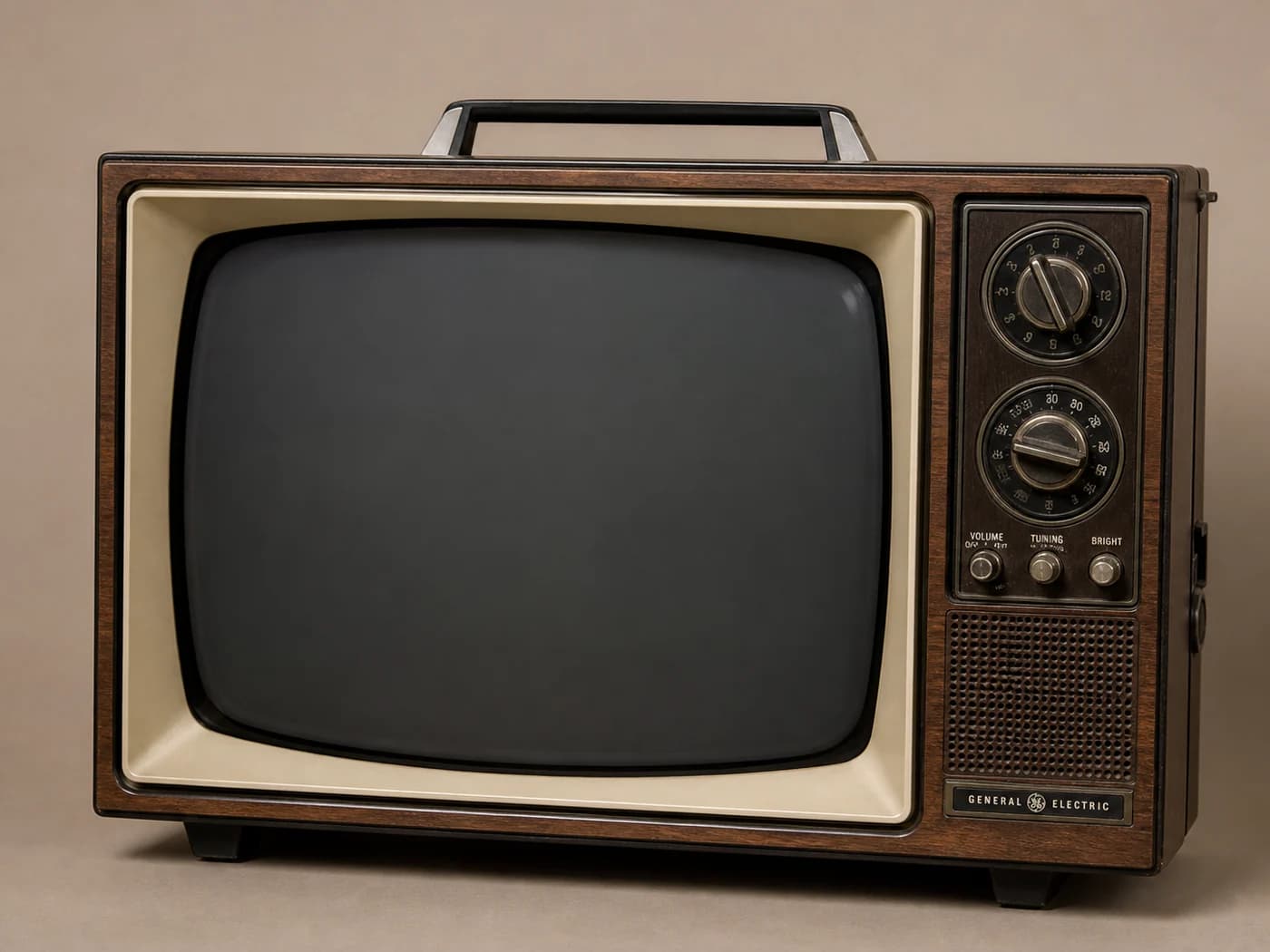 A photographically accurate 1970s General Electric Porta-Color television with a curved glass screen and separate VHF and UHF channel dials